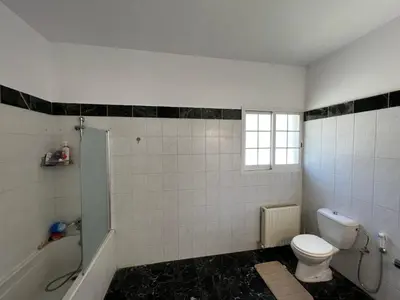 a bathroom with a toilet and a tub and a sink at Villa Sawa by Ezoria Villas in Limassol