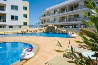 a swimming pool with two inflatable swans in a hotel at Sea View APT*Spacious balcony*200m to the Beach in Paralimni