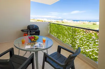 a balcony with a table and chairs and the ocean at Sea View APT*Spacious balcony*200m to the Beach in Paralimni