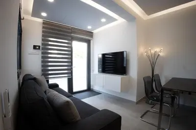 a living room with a couch and a tv at Phaedrus Living: Luxury Mackenzie Flat in Larnaka