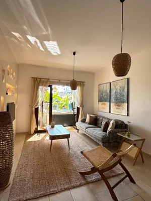 a living room with a couch and a table at Relaxing Gateway in Limassol in Episkopi Lemesou