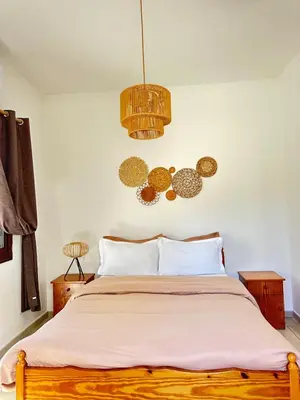 a bedroom with a bed and a chandelier at Relaxing Gateway in Limassol in Episkopi Lemesou