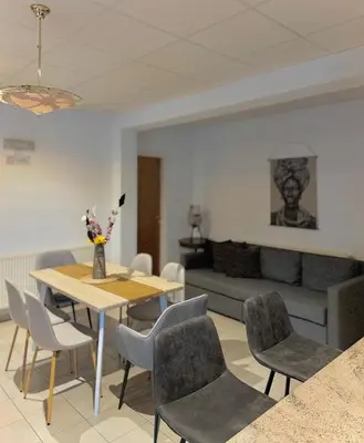 a living room with a table and chairs and a couch at Stou Stefani in Agros