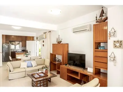 a living room with a couch and a tv at Protaras Apollon Seaside Villa in Protaras