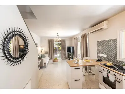 a kitchen and living room with a large mirror on the wall at Anas Kiti Seaside Villa in Meneou