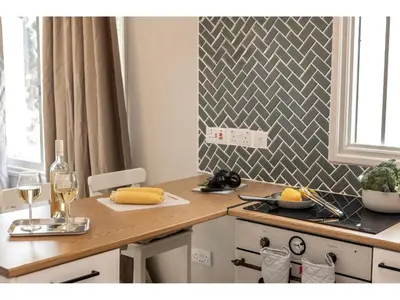 a kitchen with a counter with a table with wine glasses at Anas Kiti Seaside Villa in Meneou