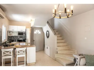 a kitchen with a staircase leading to a living room at Anas Kiti Seaside Villa in Meneou