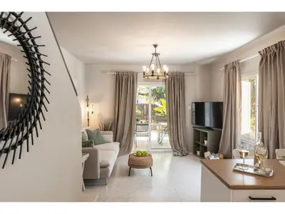 a living room with a couch and a tv at Anas Kiti Seaside Villa in Meneou