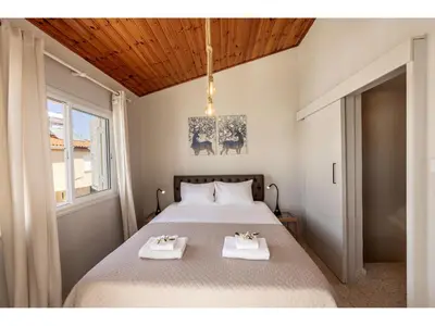 a bedroom with a bed with two white towels on it at Anas Kiti Seaside Villa in Meneou