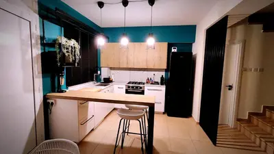 a small kitchen with a counter and a refrigerator at My Mythical Pearl in Protaras