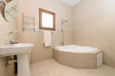 a bathroom with a sink and a bath tub at Villa Sam in Ayia Napa