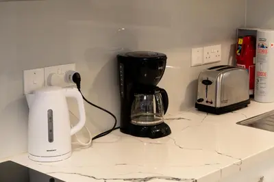 a kitchen counter with a coffee maker and a coffeemaker at Meneou Blu Beach House* in Meneou