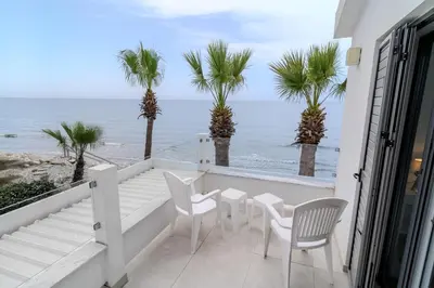a balcony with chairs and a view of the ocean at Meneou Blu Beach House* in Meneou