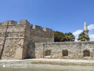a wall with two people standing on top of it at St. Lazaros Seaside Apartment in Larnaka