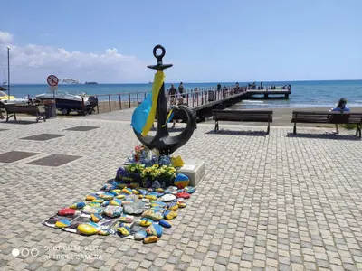 a statue of a fish on the side of a pier at St. Lazaros Seaside Apartment in Larnaka