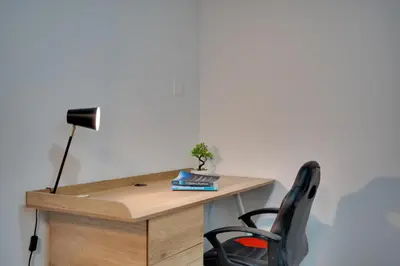 a desk with a lamp and a chair at Oroklini Star 200metres from the sandy beach in Larnaka