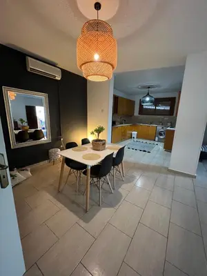 a dining room with a table and chairs at Green Door Apartment in Limassol
