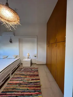 a bedroom with a bed and a rug at Green Door Apartment in Limassol