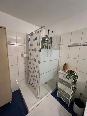 a bathroom with a shower with a glass door at Green Door Apartment in Limassol