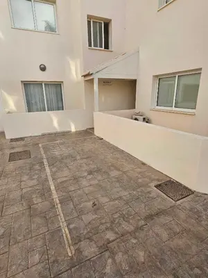 an empty room with a large white building at Sidra's Apartment in Paralimni