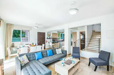 a living room with a couch and a table at Villa Cayenne in Protaras