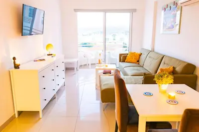 a living room with a couch and a table at Cyprus Dreams Village in Protaras