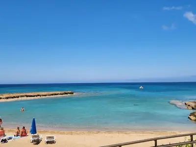 a group of people on a beach with the ocean at Yama's Villa - Polyxenia luxury, protaras, cyprus in Protaras