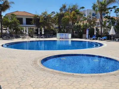 a swimming pool in the middle of a courtyard at Yama's Villa - Polyxenia luxury, protaras, cyprus in Protaras