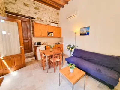 a living room with a couch and a table at Skarinou's Landhouse Poolside Heaven Apartment in Skarinou