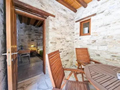 a room with two chairs and a table and a door at Skarinou's Landhouse Poolside Heaven Apartment in Skarinou