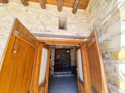 an entrance to a building with wooden doors at Traditional Village Pool Paradise Family Apartment in Skarinou