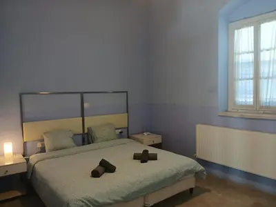 a bedroom with a bed with two brown shoes on it at Village Charm with Pool Apartment at Skarinou in Skarinou