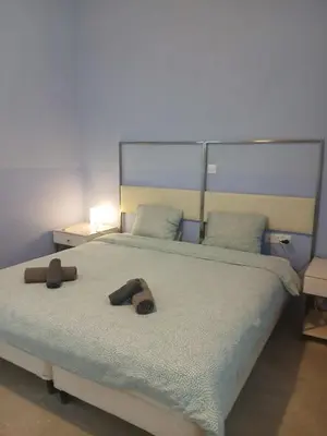 a bedroom with a bed with two slippers on it at Village Charm with Pool Apartment at Skarinou in Skarinou