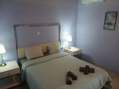 a bedroom with a bed with two shoes on it at Village Charm with Pool Apartment at Skarinou in Skarinou