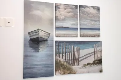 a group of four paintings on a wall at Musan Boutique Apartments in Ayia Napa