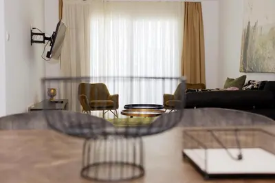 a living room with a couch and a table at Musan Boutique Apartments in Ayia Napa