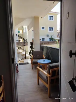 a view of a balcony with a couch and a table at Vicky apartment in Paralimni