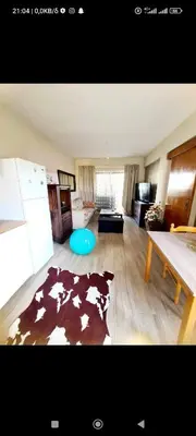 a living room with a cow rug on the floor at Vicky apartment in Paralimni