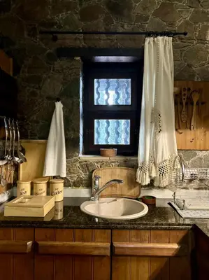 a kitchen counter with a sink and a window at FIKARDOU ALMOND PARK in Phikardhou
