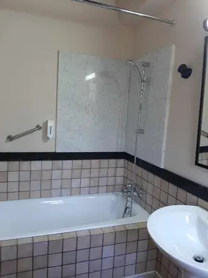 a bathroom with a bath tub and a sink at FIKARDOU ALMOND PARK in Phikardhou