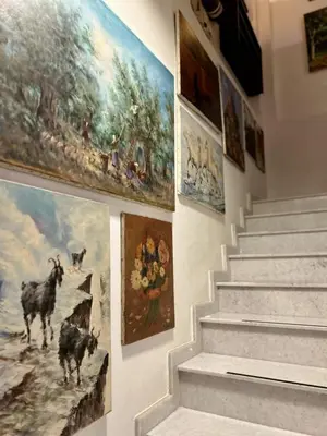 a set of stairs with paintings on the wall at FIKARDOU ALMOND PARK in Phikardhou