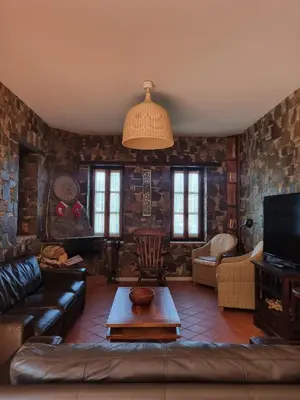 a living room with a couch and a table at FIKARDOU ALMOND PARK in Phikardhou