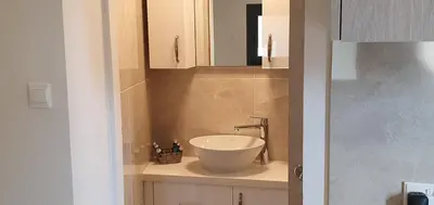 a bathroom with a sink and a mirror at Chic Elegance Meets Village Gem in Pelendri
