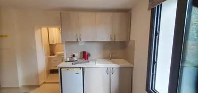 a small kitchen with a sink and a counter at Chic Elegance Meets Village Gem in Pelendri
