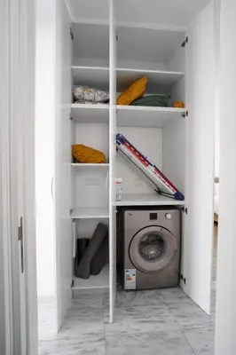 a white closet with a washing machine in it at Seaview Pearl in Mackenzie with Pool & Jacuzzi in Larnaka