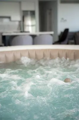 a hot tub with green water in a room at Seaview Pearl in Mackenzie with Pool & Jacuzzi in Larnaka