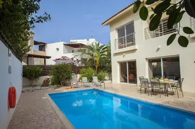 a swimming pool in front of a house at Villa Cliantha in Protaras