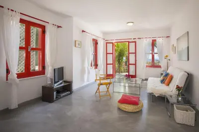 a living room with a couch and a tv at Liora Suite in Protaras