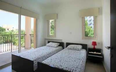 two beds in a bedroom with a balcony at Michelle 8 in Protaras