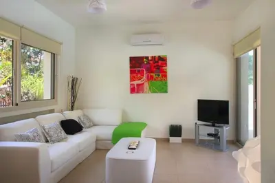 a living room with a white couch and a tv at Michelle 8 in Protaras